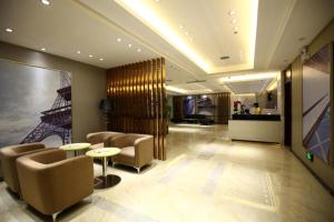 a lobby with chairs and tables in a building at City Comfort Inn Hotel Guiyang Normal University Yangmingci Metro Station in Guiyang
