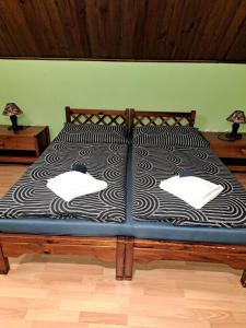a black and white bed with two pillows on it at Hotel Autis in Vysoké Tatry
