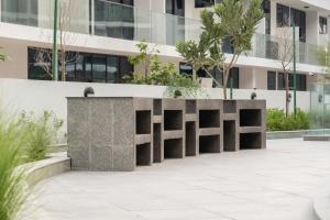 a concrete bench in front of a building at Artful Gate Loft near Airport - Masdar City in Abu Dhabi