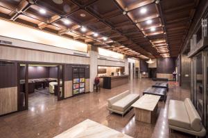 a lobby with benches and tables in a building at Twinstar Hotel in Taichung