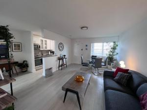 a living room with a couch and a table at Unique Water Views, free Parking 1bed 1 bath Rooffornomads 416 in Miami Beach