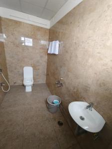 a bathroom with a sink and a toilet at Goldwins Grand A comfort stay in Coimbatore