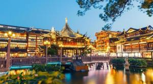 a large building with a river in front of it at Xana Hotelle·Shanghai Expo Park Xizang Nan Road in Shanghai