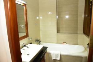 a bathroom with a white tub and a sink at cockpit tower at colombo airport in Katunayake +14 photos