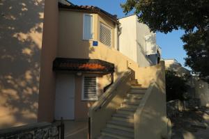 a stairway leading up to a white building at Apartment Omerovic in Novalja