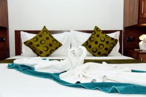 a bed with white towels and two swans on it at cockpit tower at colombo airport in Katunayake