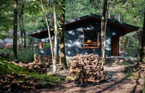 a cabin in the woods with a pile of logs at Nold forest house - Vacation STAY 17551v in Nasu-yumoto
