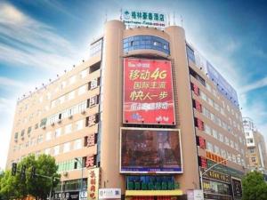 a large building with signs on the side of it at GreenTree Inn Jiangxi Yingtan Jiaotong Road Central Square Business Hotel in Yingtan