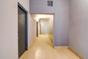 pasillo con paredes blancas, suelo de madera y puerta en Hotel O Neatflix &Chill, en Khandagiri 29 fotos más