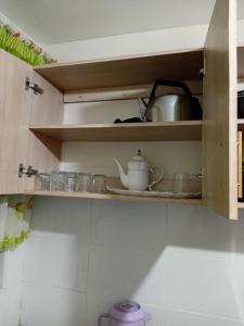 a cupboard with a tea pot on a shelf at Jeff HOMES Bnb in Nakuru