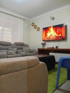 a living room with a couch and a fire on the wall at Jeff HOMES Bnb in Nakuru