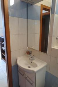 a bathroom with a sink and a mirror at Apartment Omerovic in Novalja +27 photos
