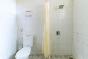 a bathroom with a toilet and a shower at Andrin Daspatt Family Inn in Makassar +37 photos
