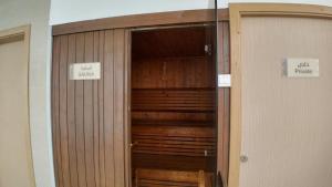 a closet with a wooden door in a room at Best Western Plus Jeddah Hotel Madinah Road in Jeddah