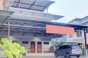 a car parked in front of a building with a sign at Hotel O Mulia Bangka in Pangkalan Baru +55 photos