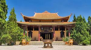 a large building with a statue in front of it at ADALY Hotel in Xuan An