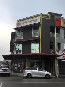 a silver car parked in front of a building at BENUTHOMESTAY in Kampong Parit Tengah +29 photos