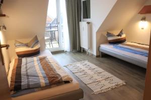 a small room with a bed and a window at Ferienwohnung mit Seeblick und Schwimmbadnutzung in Cuxhaven in Cuxhaven +16 photos