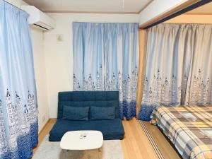 a bedroom with a couch and a bed and a window at 貸切 2部屋5名可能 駅近い徒歩6分 秋葉原 新宿 鎌倉へ直通 スカイツリー ディズニーランド近く 悠悠之家 in Tokyo