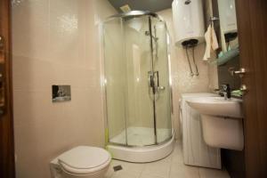 a bathroom with a shower and a toilet and a sink at Batumi Royal Apartments in Batumi +56 photos