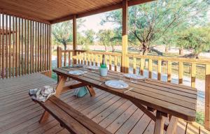 a wooden picnic table on a wooden deck at Rubina Resort in Empuriabrava
