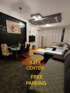 a living room with a bed and a dining room at Djurdja apartment, free parking in Novi Sad