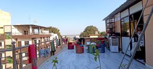 a balcony of a building with buckets on it at Golden River Homestay in Varanasi