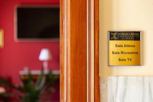 a sign on a door that reads safe address sahirir safe therapeutic sa at Syraka Hotel LR Collection in Siracusa