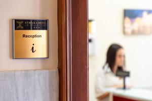 a sign on a door that says reception at Syraka Hotel LR Collection in Syracuse +90 photos