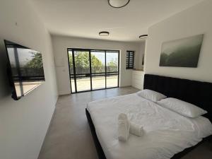 a bedroom with a bed with two white pillows on it at וילה יובל in Yuval