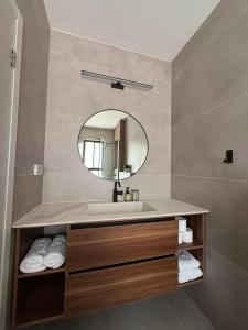 a bathroom with a sink and a mirror at וילה יובל in Yuval