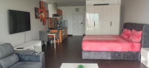a living room with a bed and a couch at Pattaya Beach View Talay 6 by AEGEAN Suite Condo in Pattaya Central +36 photos
