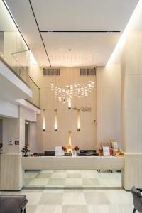 a large lobby with a large chandelier at Wachi Hotel in Songkhla
