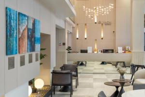 a lobby with chairs and a reception desk at Wachi Hotel in Songkhla
