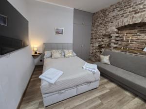 a bedroom with a large bed and a couch at Placeo in Katowice