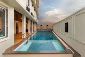 a swimming pool in the middle of a building at The Colonial - A Lake View Hotel in Udaipur in Udaipur