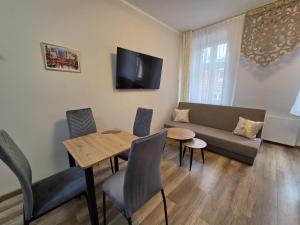 a living room with a couch and a table at Placeo in Katowice