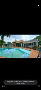a picture of a house with a swimming pool at Blackwood Guesthouse in Vereeniging