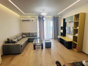 a living room with a couch and a table at Sea view apartament in Durrës