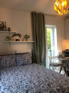 a bedroom with a bed and a table and a window at Apartment Prague Airport- 5 minute drive from AirPort in Tuchoměřice