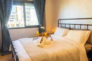 a bedroom with a large bed with a window at Ocean Park Sunset Escape beach front with swimming pool in Aïn Harrouda +9 photos