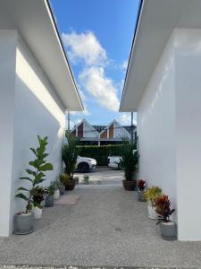 a courtyard with potted plants in a building at A&J Holiday Villa in Ban Na Bon