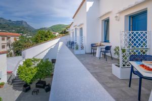 a balcony with tables and chairs on a building at Villa Azzurra in Vico Equense