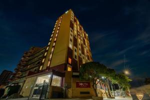 a tall building with a sign in front of it at Carnelian South Suite in Nairobi