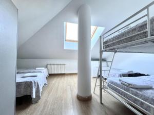 a bedroom with two bunk beds and a ladder at BaruHaus Duplex Valencia de don Juan 2 in Valencia de Don Juan