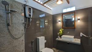 a bathroom with a shower and a toilet at Villa Coleus in Tangalle +40 photos