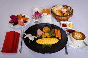a table with a plate of food on a table at Green Amazon Residence in Siem Reap