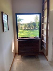 a window in a room with a dresser with a view at La Caballeriza in Mercedes