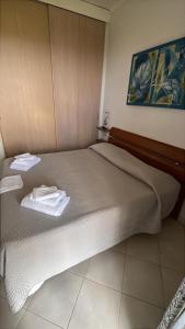 a bedroom with a bed with two towels on it at La Vista Agriturismo Boutique in Ariccia