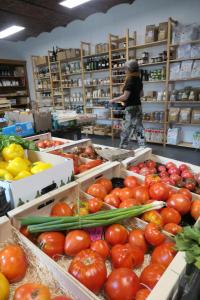 a woman in a grocery store with tomatoes and vegetables at Gîte de La Blanche Ferme près de Pairi Daiza in Lessines +21 photos
